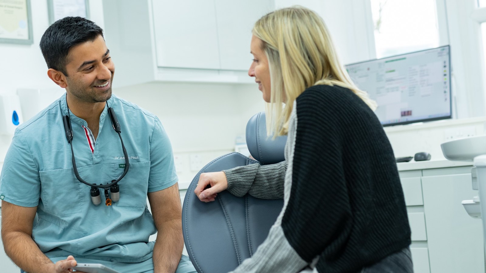 Dr Aman Phull chatting with a patient before her appointment at Chalfont Dentist